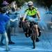 HVA Paramedic Rachel Brunelle of Chelsea rides her bike through a color zone during the Color Run 5K in downtown Ypsilanti July 22.
Jeffrey Smith | AnnArbor.com